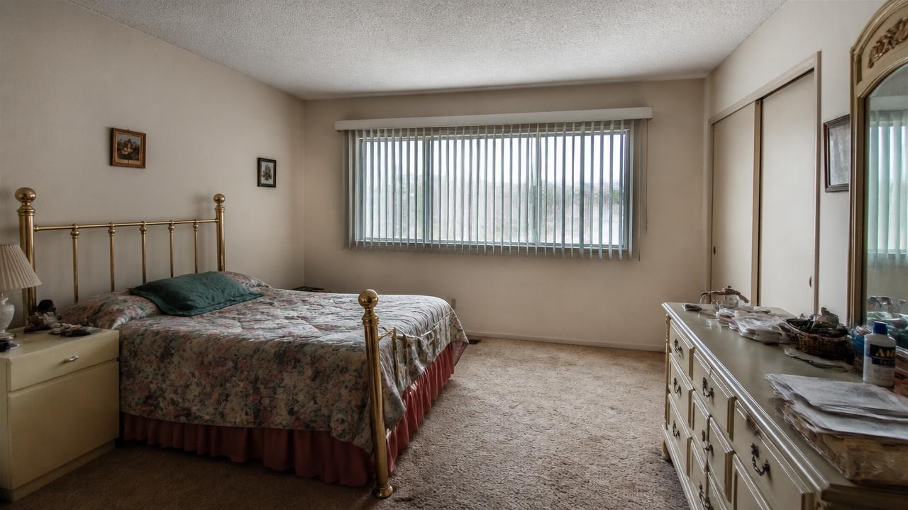 Bedroom as it sits between tenants, worn but not damaged